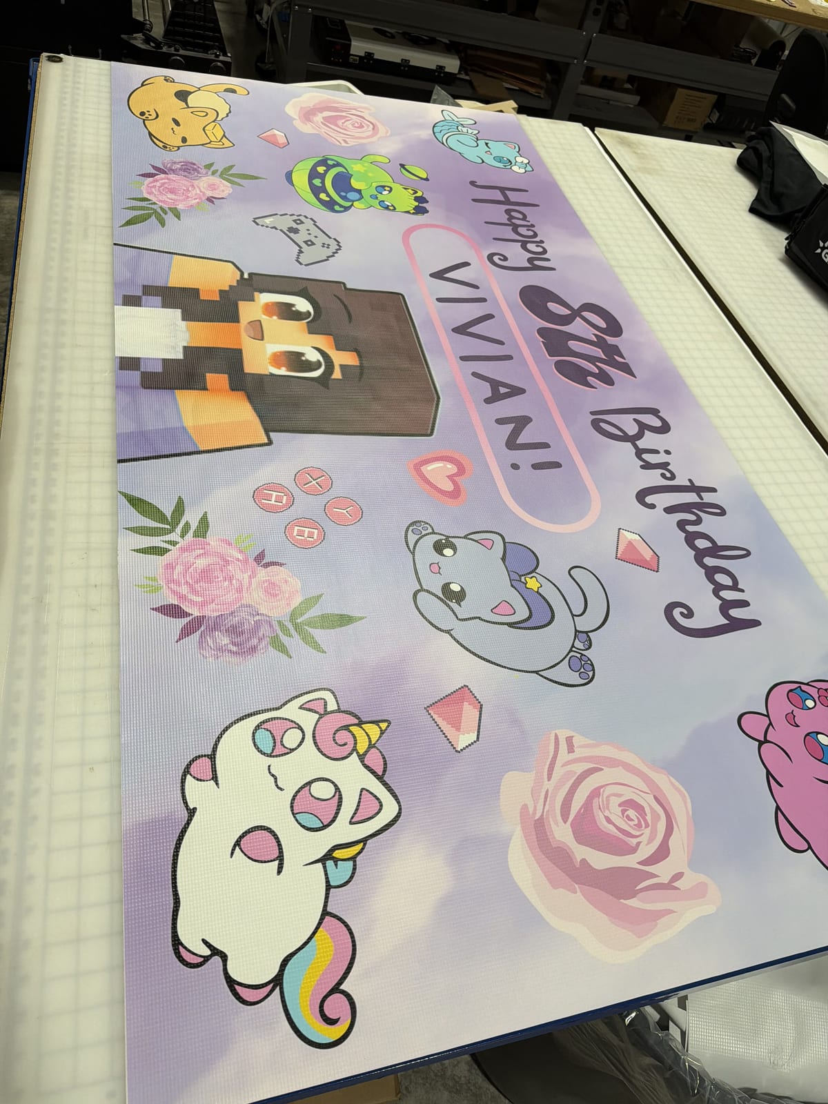 Full-color birthday backdrop banner on the cutting table