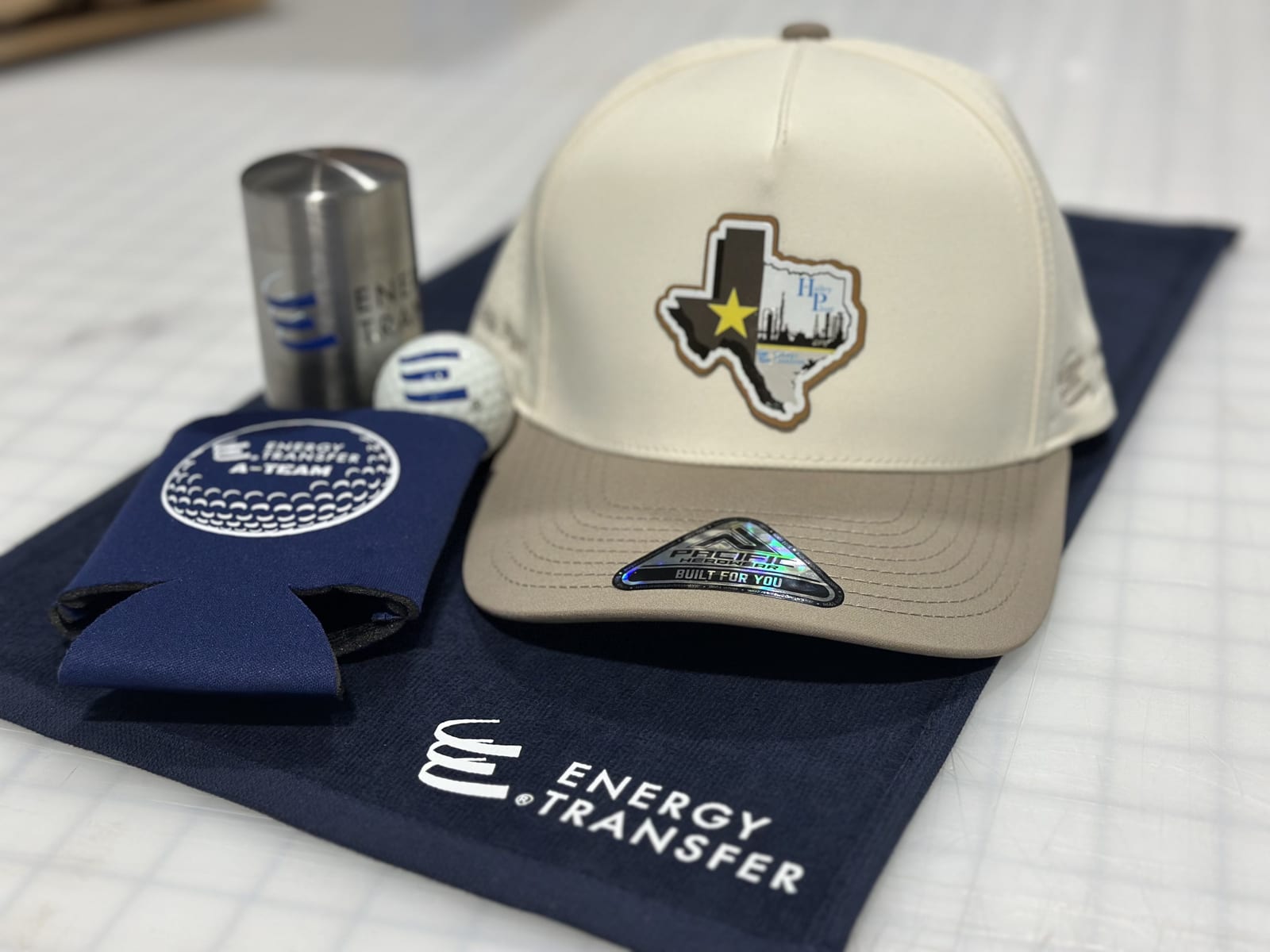 Branded golf event kit: patch cap, towel, koozie, and printed golf ball
