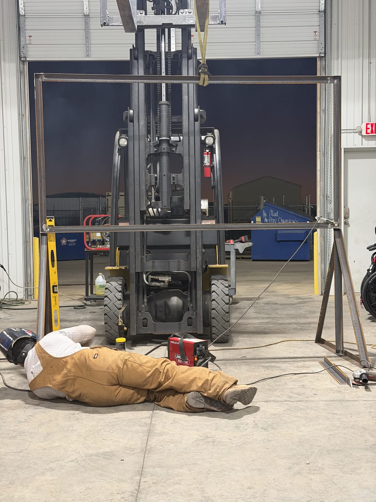 Welder building a steel sign frame on the Print A Vision shop floor