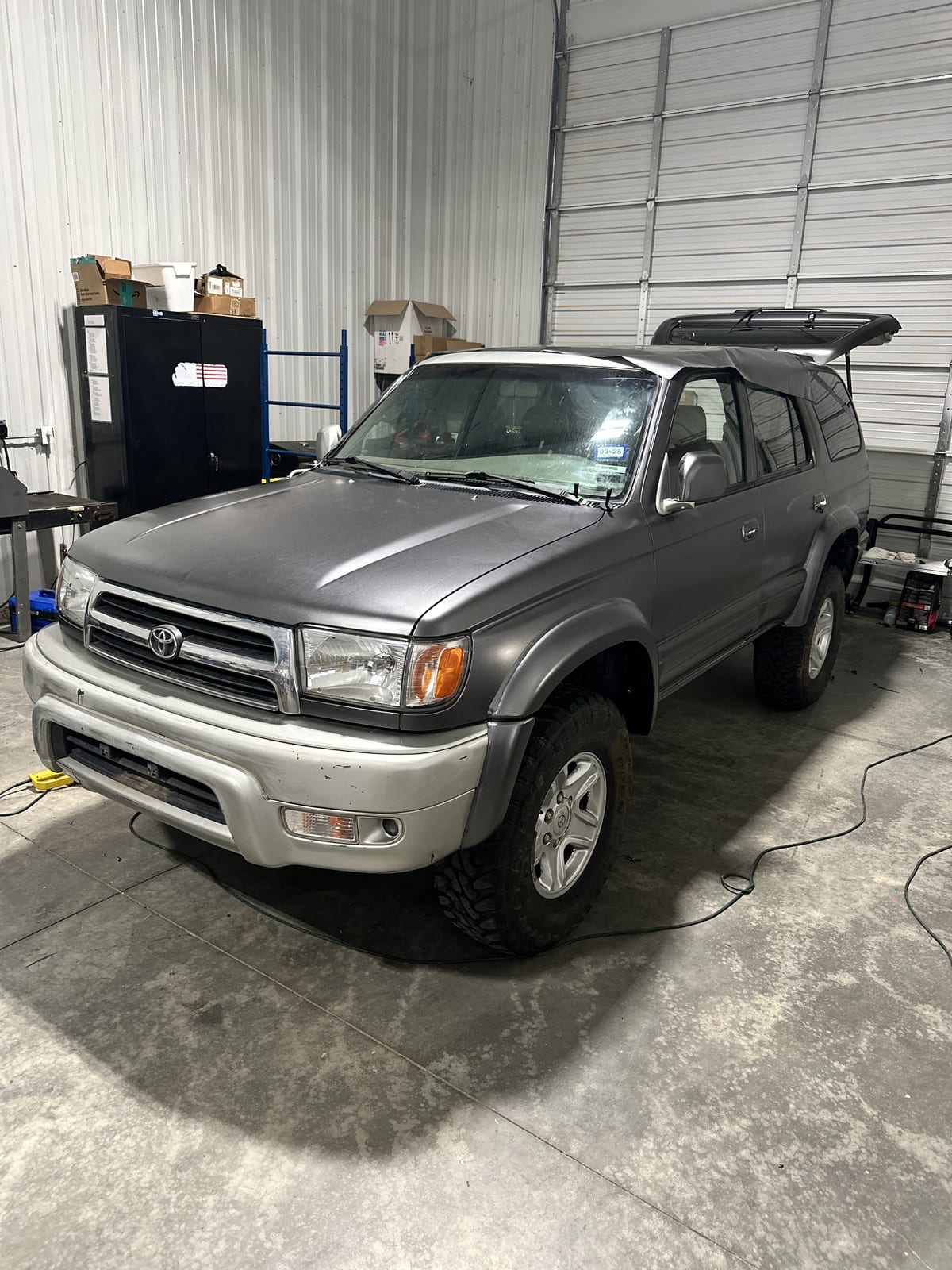 Matte gunmetal color-change wrap, mid-install