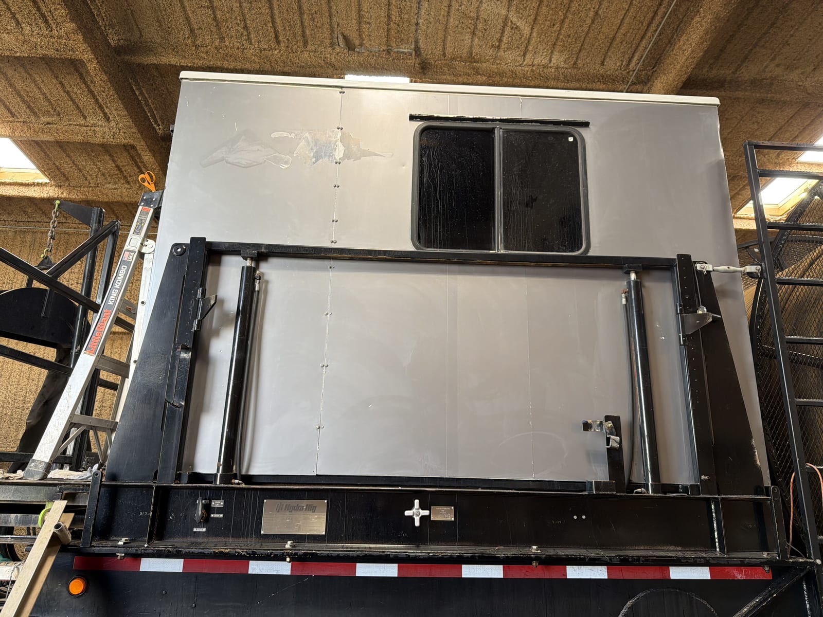 Bare sheet-metal Hydra-Rig control cab before wrapping